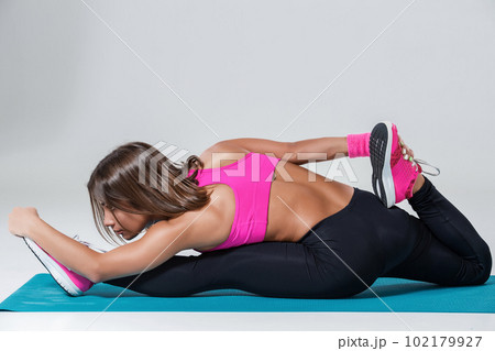 Sporty flexible girl doing stretching exercise Sporty flexible girl doing stretching exercise 102179927