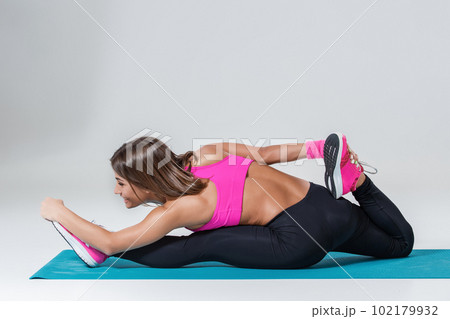 Sporty flexible girl doing stretching exercise Sporty flexible girl doing stretching exercise 102179932