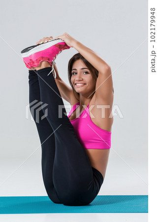 Sporty flexible girl doing stretching exercise Sporty flexible girl doing stretching exercise 102179948