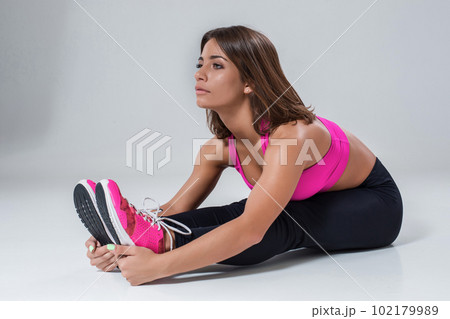 Sporty flexible girl doing stretching exercise Sporty flexible girl doing stretching exercise 102179989