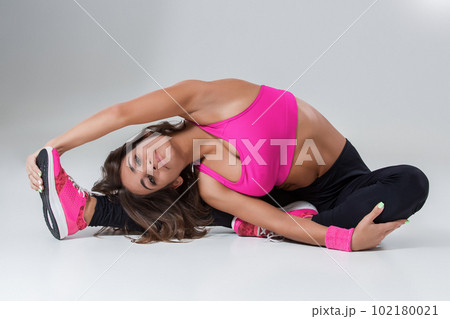 Sporty flexible girl doing stretching exercise Sporty flexible girl doing stretching exercise 102180021