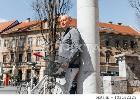 Portrait of a handsome hipster man. A man in a big city cycling down the street on a bicycle, a life style concept 102182225