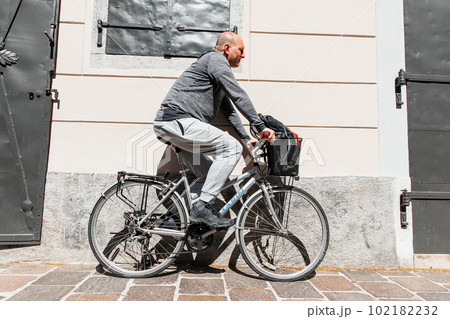 Portrait of a handsome hipster man. A man in a big city cycling down the street on a bicycle, a life style concept 102182232