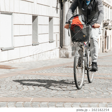 Portrait of a handsome hipster man. A man in a big city cycling down the street on a bicycle, a life style concept Portrait of a handsome hipster man. A man in a big city cycling down the street on a bicycle, a life style concept 102182254
