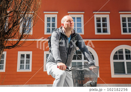 Portrait of a handsome hipster man. A man in a big city cycling down the street on a bicycle, a life style concept 102182256