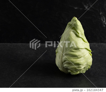Cone head cabbage for dietary, vegan on a black background, concept, stock photo	 102184347