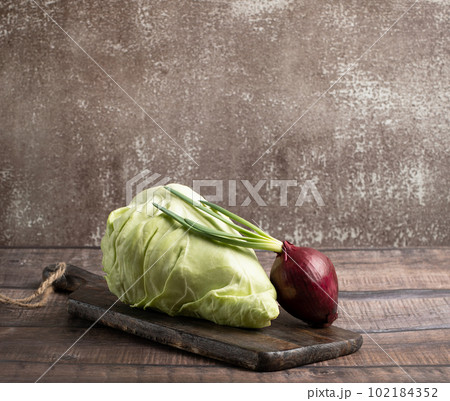Cone head cabbage for dietary and onion, vegan on a wooden background, concept, stock photo Cone head cabbage for dietary and onion, vegan on a wooden background, concept, stock photo 102184352