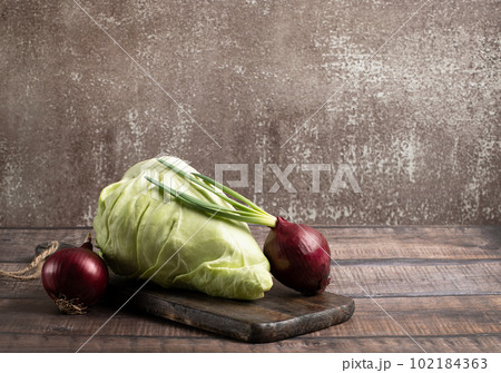 Cone head cabbage for dietary and onion, vegan on a wooden background, concept, stock photo	 102184363