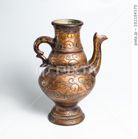 Copper object old Jug. Handcraft Decorative interior. Ancient Style. White background. Art. Stock photo. Selective focus.	 102184370