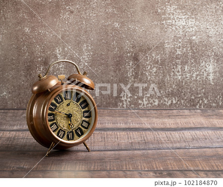 Old vintage alarm on a brown background	 102184870