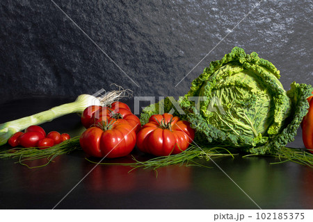 Fresh savoy cabbage, paprika, green onion, tomatoes on grey background. Top view detox concept, vegan, food cooking ingredients	 102185375