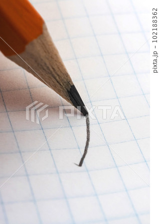 Writing with pencil on white paper closeup 102188362