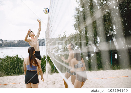 Sports and active life theme. Young players play volleyball. Beach playground. Sports and active life theme. Young players play volleyball. Beach playground. 102194149