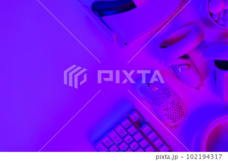 Modern gaming accessories on purple desk 102194317