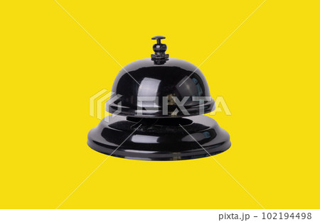 Reception bell on yellow background Reception bell on yellow background 102194498