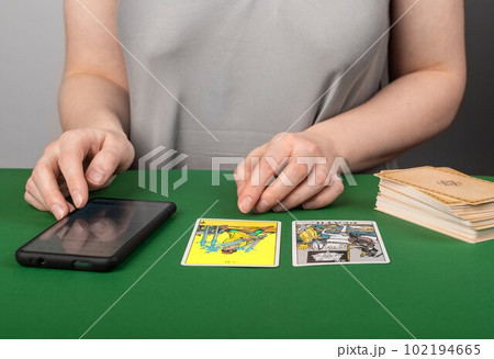 Lodz, Poland March 31 2023 Tarot card reading with mobile app, phone. Modern fortune teller with smartphone Lodz, Poland March 31 2023 Tarot card reading with mobile app, phone. Modern fortune teller with smartphone 102194665
