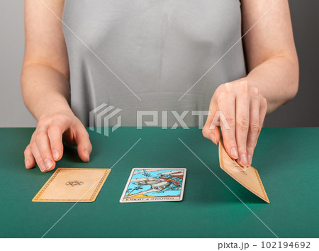 Lodz Poland April 15 2023 tarot reader, fortune teller with tarot cards during divination Lodz Poland April 15 2023 tarot reader, fortune teller with tarot cards during divination 102194692