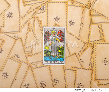 Lodz Poland April 15 2023 Temperance, major arcana on tarot cards deck background. Taro divination concept Lodz Poland April 15 2023 Temperance, major arcana on tarot cards deck background. Taro divination concept 102194762