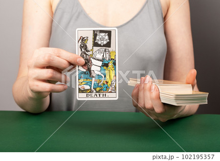 Lodz, Poland April 07 2023 Death tarot card, major arcana with skeleton, horse rider in hand of fortune teller 102195357