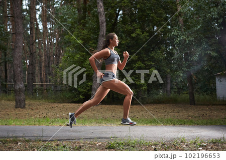 Young woman running outdoors in a city park Young woman running outdoors in a city park 102196653