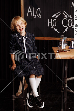 Schoolgirl doing a chemical experiment Schoolgirl doing a chemical experiment 102197535