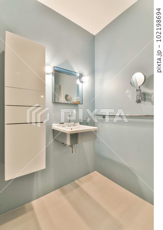 a bathroom with a sink and mirror on the wall above it is an image of someone's reflection in the mirror a bathroom with a sink and mirror on the wall above it is an image of someone's reflection in the mirror 102198694