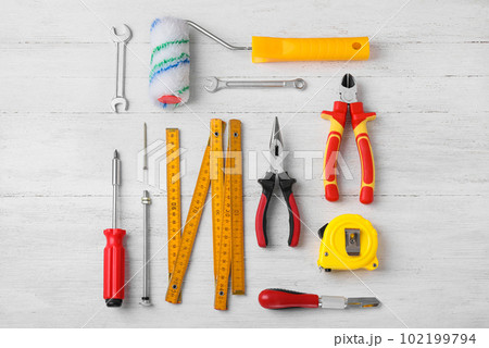 Flat lay composition with different construction tools on white wooden background 102199794