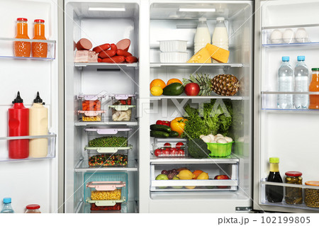 Open refrigerator full of different fresh products 102199805