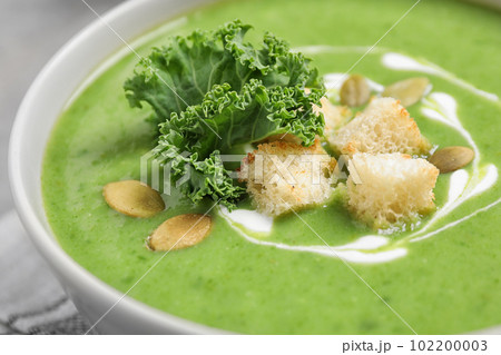 Tasty kale soup with croutons on table, closeup Tasty kale soup with croutons on table, closeup 102200003