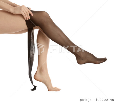 Woman putting on tights on white background, closeup 102200140