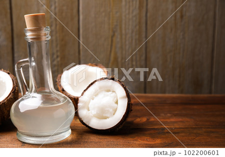 Coconut oil on wooden table. Space for text 102200601