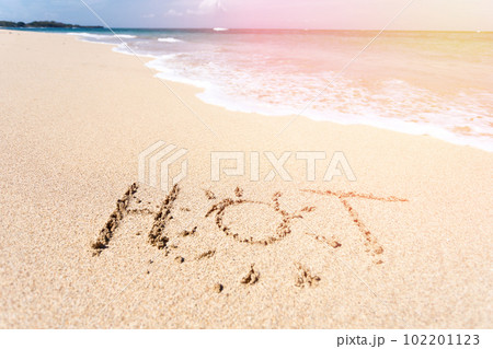 The word HOT written in the sand on beach 102201123