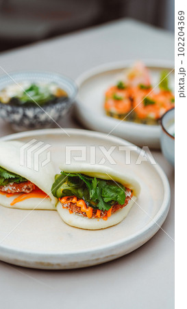 Vertical view of the tasty appetizer on white plate at restaurant background 102204369