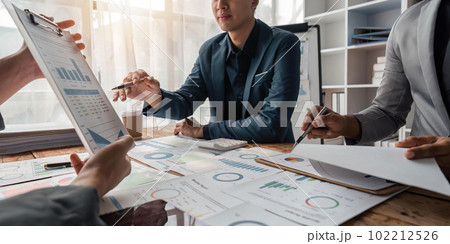 Business team presents and explains and using tablet discuss marketing numerical charts that display financial budgets, investments, project plans Business team presents and explains and using tablet discuss marketing numerical charts that display financial budgets, investments, project plans 102212526