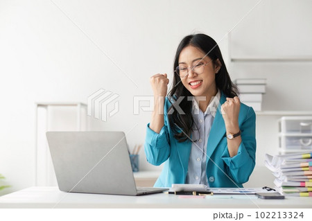 Young happy business woman worker or feeling excited winning online looking at laptop celebrating professional achievement, getting hired or approved at work Young happy business woman worker or feeling excited winning online looking at laptop celebrating professional achievement, getting hired or approved at work 102213324
