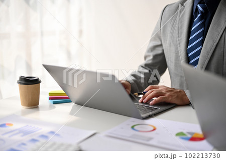 Close-up image of a professional Asian businessman using his laptop Close-up image of a professional Asian businessman using his laptop 102213730