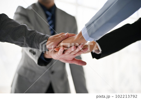 Top view of diverse businesspeople putting their hands together during the meeting. 102213792