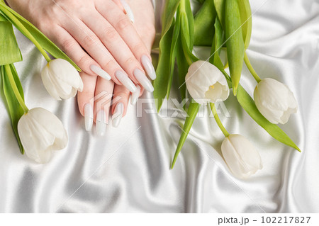 Female hand with spring nail design. 102217827