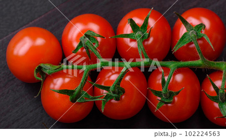 Delicious fresh cherry tomatoes on a twig with spices and herbs 102224563