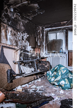Destroyed housing after the fire, burnt things, soot and coals everywhere Destroyed housing after the fire, burnt things, soot and coals everywhere 102229042