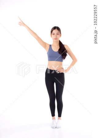 Portrait of beautiful young asian woman in sportwear smile and presenting isolated. Portrait of beautiful young asian woman in sportwear smile and presenting isolated. 102229557
