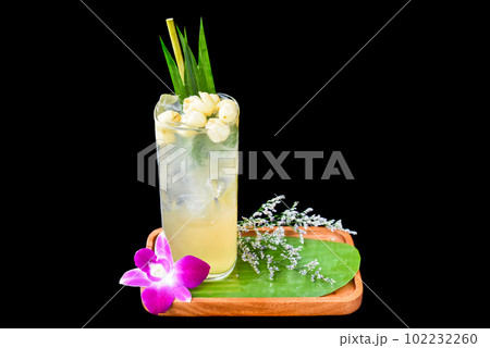 Coconut water with lotus seeds on wooden plate isolated on black background Coconut water with lotus seeds on wooden plate isolated on black background 102232260