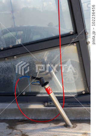 A high-pressure washing gun in a holder A high-pressure washing gun in a holder 102236456