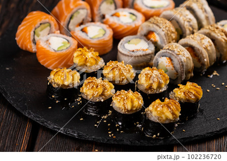 Rolls set with fish shrimp and caviar sushi with chopsticks - asian food and japanese cuisine concept 102236720