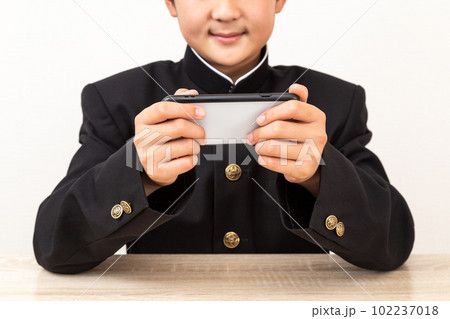 スマホを使う中学生 102237018