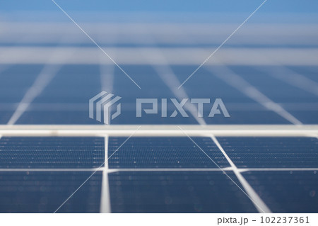Close-up on solar panels and flower - alternative energy production. Close-up on solar panels and flower - alternative energy production. 102237361