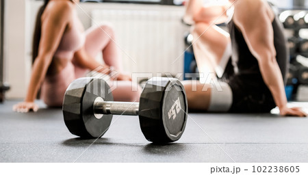 Unrecognizable sportspeople talking in gym 102238605