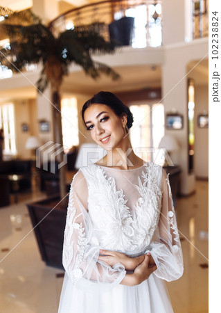 Beautiful bride in fashion wedding dress with a long luxury veil. The stunning young bride is incredibly happy. Beautiful bride in fashion wedding dress with a long luxury veil. The stunning young bride is incredibly happy. 102238824