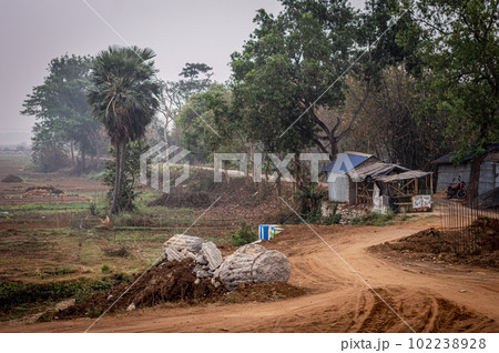U Shaped dirt road of a rural village. Summer Landscape. Rural India. Bankura West Bengal India South Asia Pacific U Shaped dirt road of a rural village. Summer Landscape. Rural India. Bankura West Bengal India South Asia Pacific 102238928