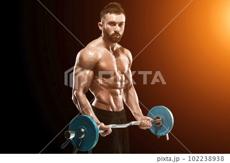 muscular man lifting weights over dark background muscular man lifting weights over dark background 102238938